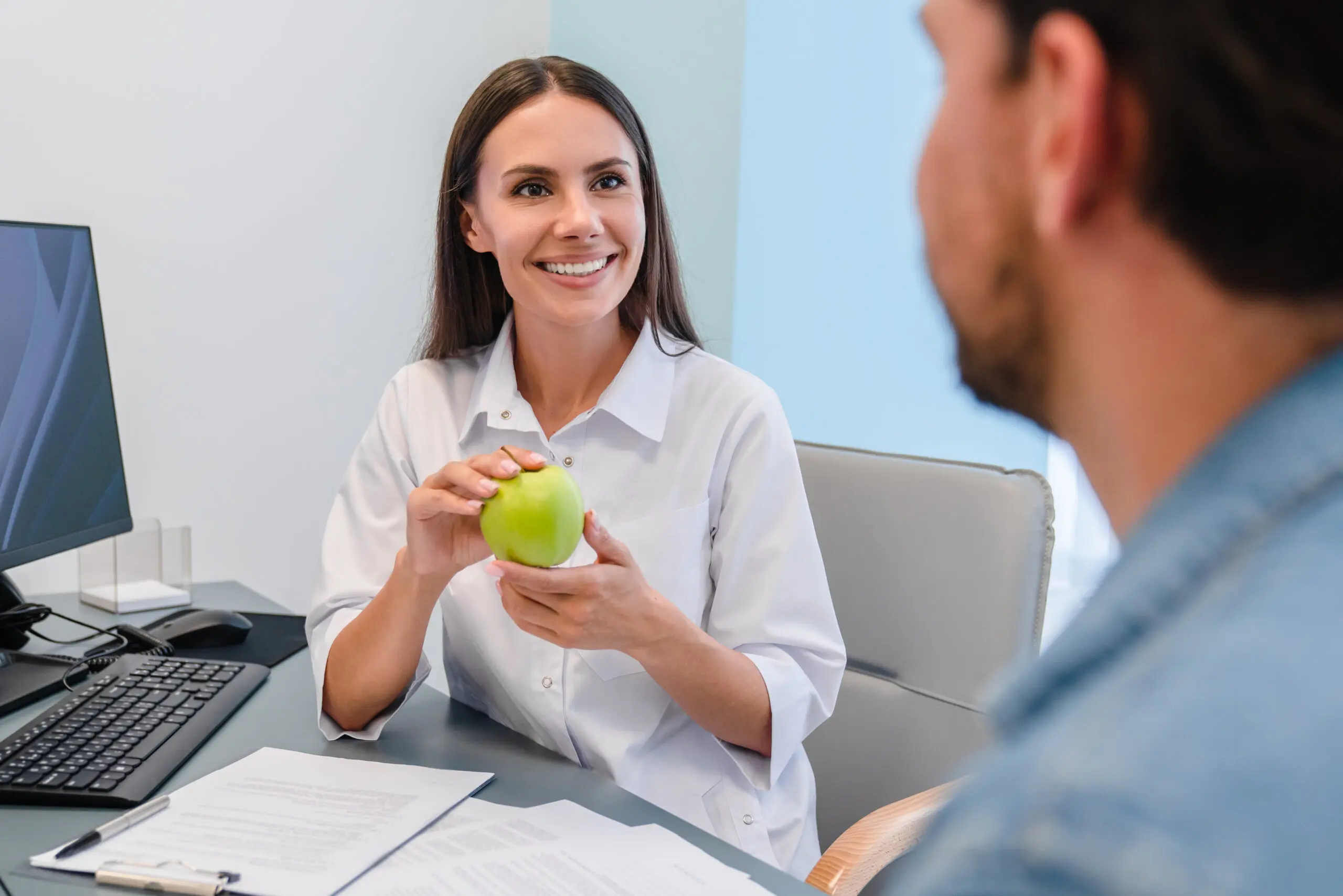 A woman holding an apple in her hand.