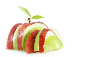 A sliced apple with red and green stripes.