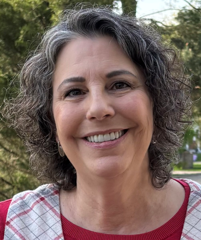 Deborah Halvorson A woman with grey hair smiling for the camera.