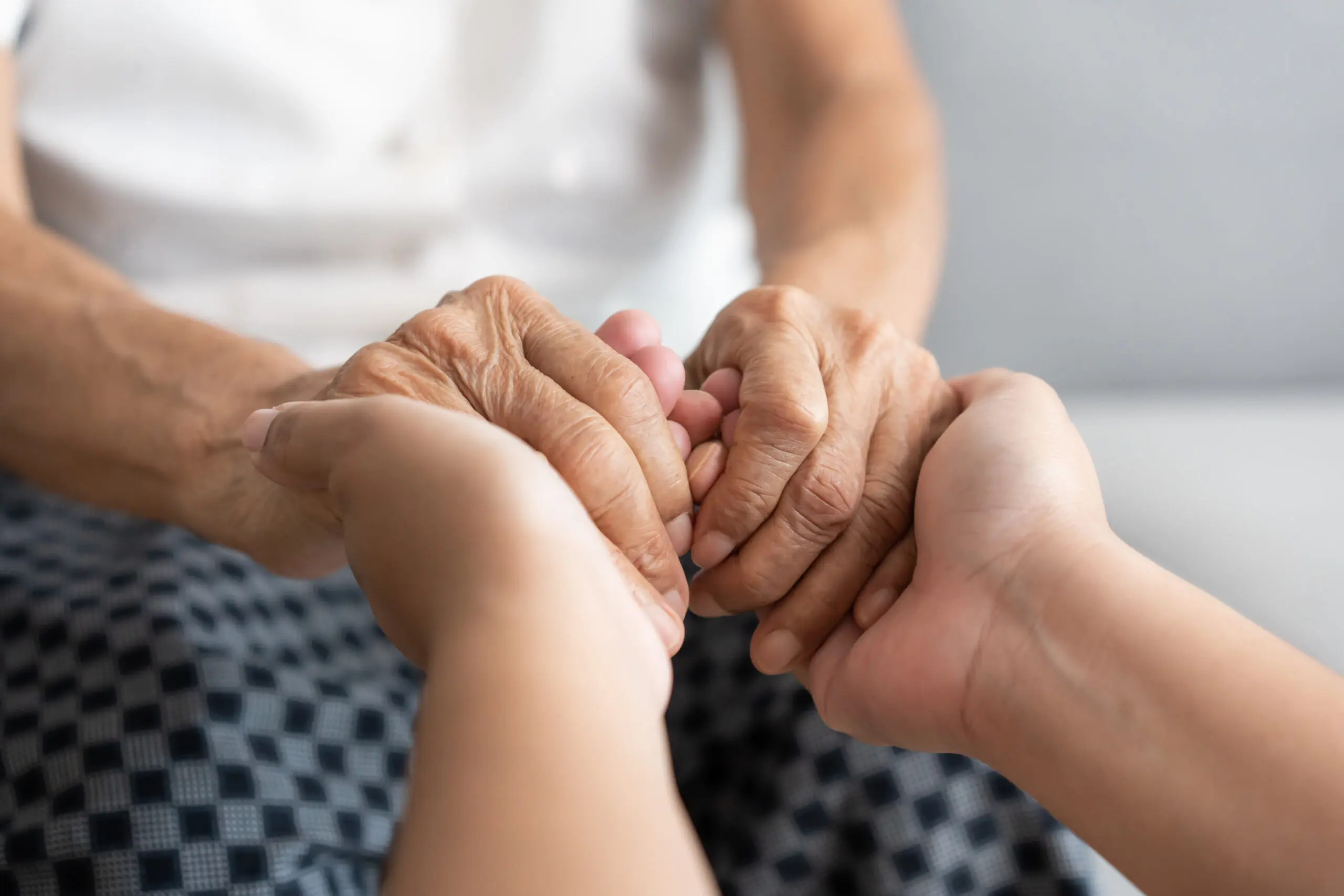 Young and senior woman holding each other hands togetherness concept A group of people holding hands in the middle of a circle.