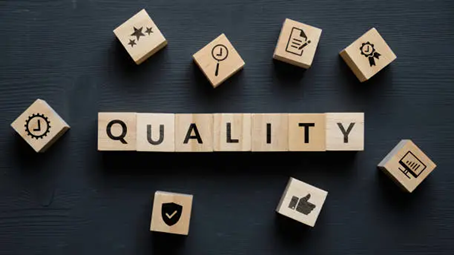 Quality Assurance A table with scrabble tiles that spell out quality.