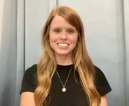 Teena Pacheco A woman with long hair and wearing a black shirt.