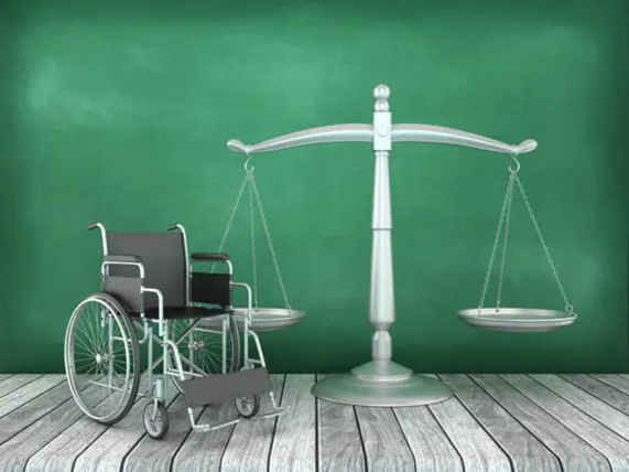 Weights A wheelchair and scale in front of a green wall.