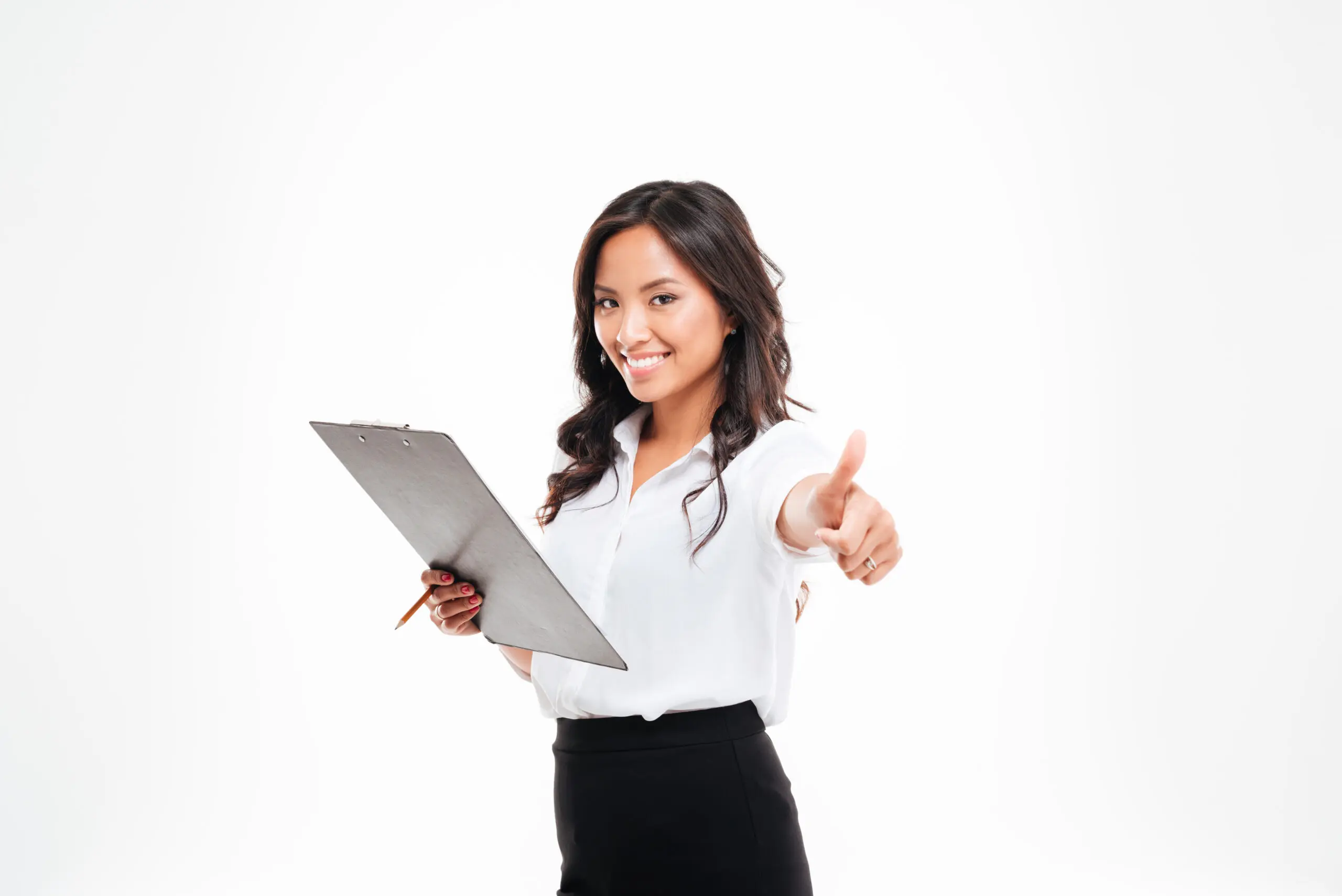 Friendly young smiling businesswoman with clipboard showing thumbs up gesture A woman holding papers and giving the thumbs up.