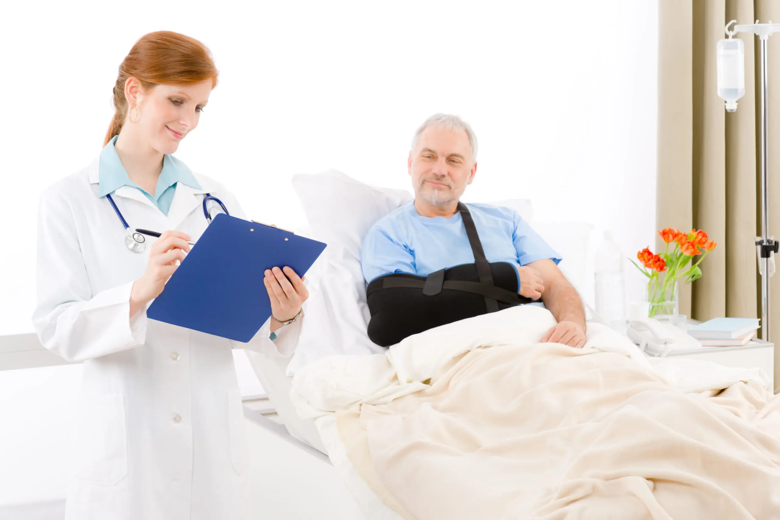 Hospital - doctor examine patient broken arm A doctor and a patient in hospital bed.